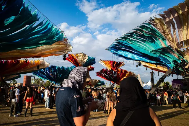 Visitors beneath colorful festival canopies